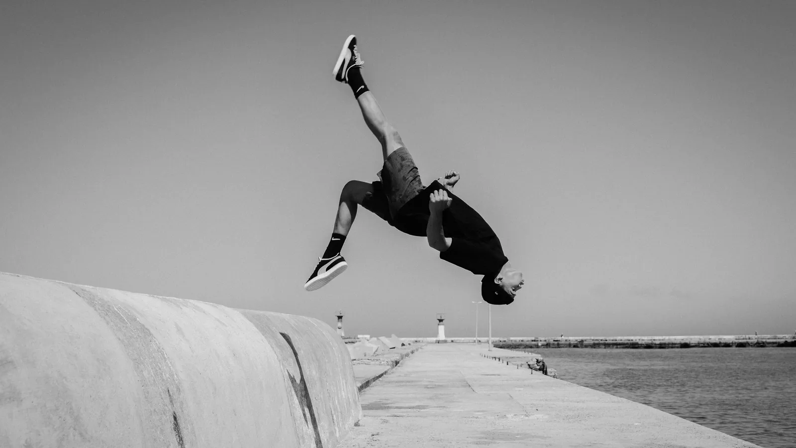 Cameron Groep mid-flip on the harbour wall