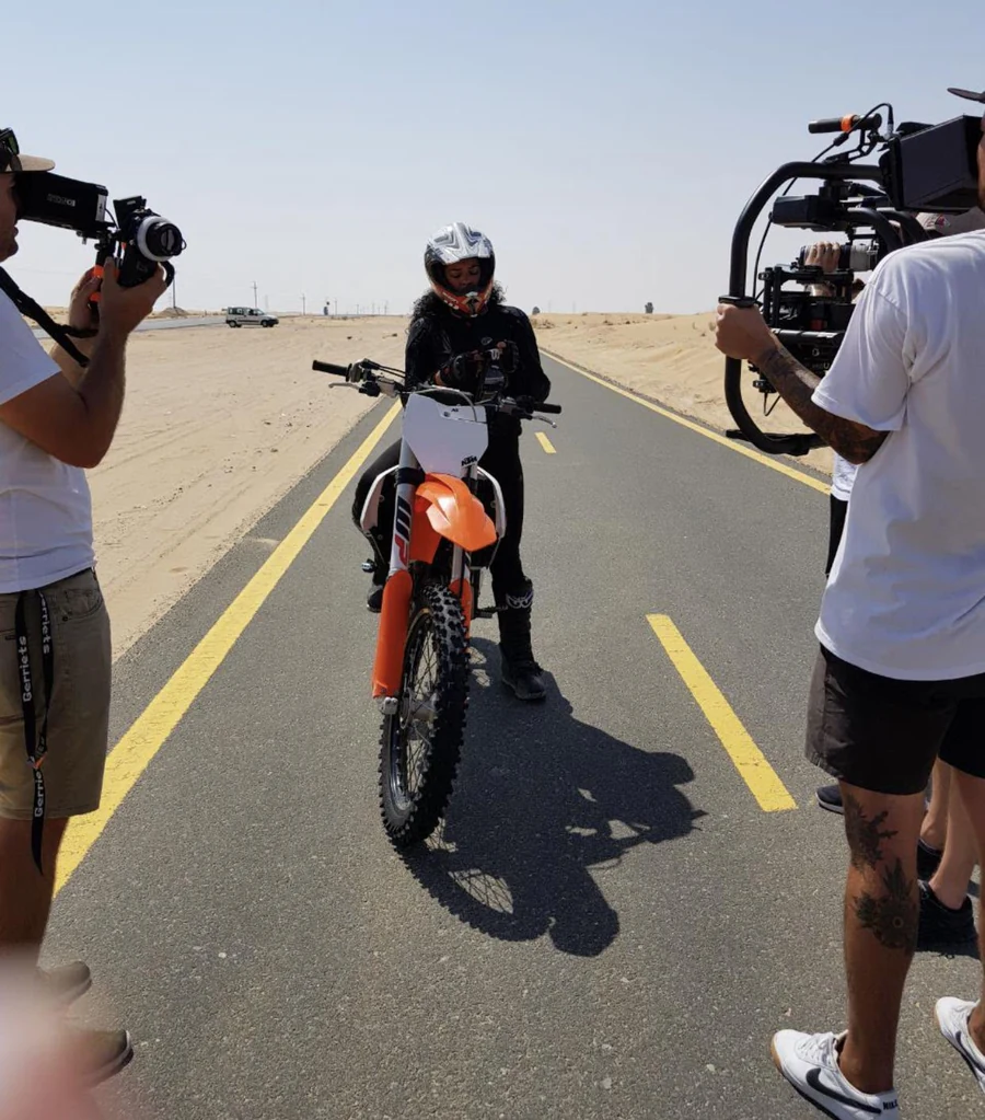 On a motorcycle, filming